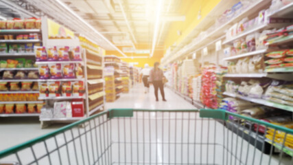 Blur image of consumer shopping in supermarkets in shopping mall interior for background. - obrazy, fototapety, plakaty