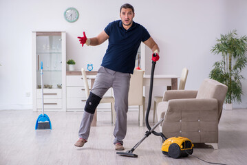 Young leg injured contractor cleaning the house