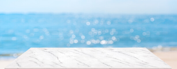 summer background.Empty perspective marble table with blur sea and sky bokeh background, banner...