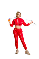 Young Fitness woman in red training dress. With a rope in his hands. Isolate on white background.