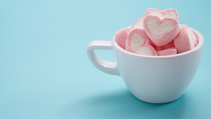Pile of colorful pink heart marshmallows in cup