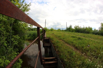 old grassy bridge over the river