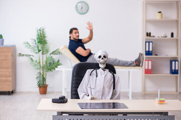 Young man visiting dead doctor