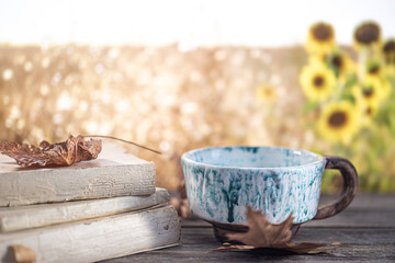 Autumn composition with books and a beautiful Cup