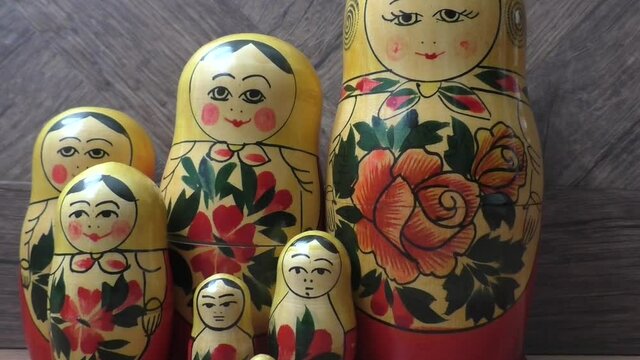 Matryoshka - Russian folding doll made of wood, inside which there are dolls of smaller size. Semenovskaya matryoshka is painted bright, with black hair, a handkerchief on her head. Retro