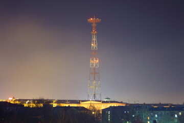 high illuminated communication tower at night