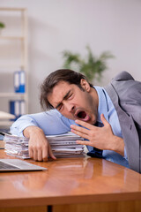 Young male employee sleeping in the office