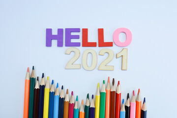 Hello 2021 on colored block letters with colored pencils on white background 