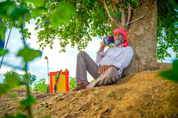 Indian farmer talking mobile phone at Agriculture field