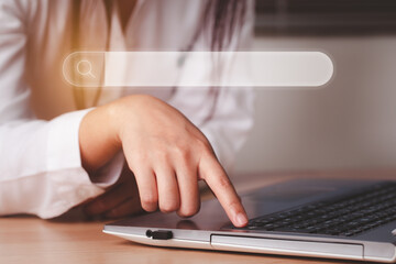 Woman hand are pressing a button to find out online what interests them using their laptop...