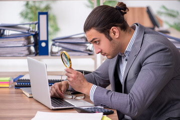 Young male employee businessman at workplace