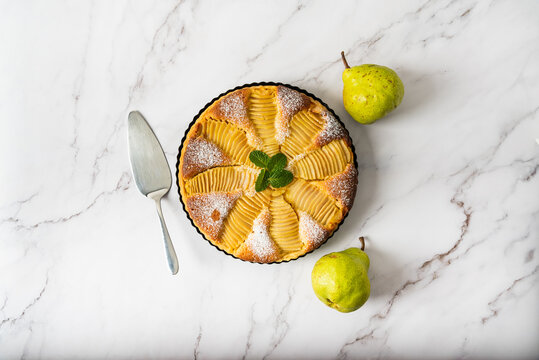 Homemade pear tart on a marble background