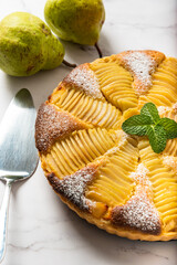 Homemade pear tart on a marble background