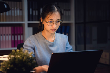 Students are using laptop to study online learning on the Internet at home in night.