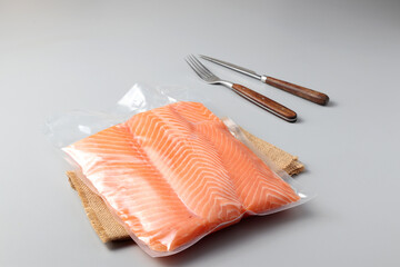 Salmon fillets in a vacuum package. Sous-vide, new technology cuisine. Selective focus, copy space
