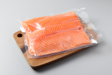 Salmon fillets in a vacuum package. Sous-vide, new technology cuisine. Selective focus, copy space