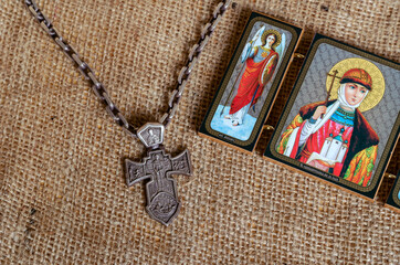 A massive silver pectoral cross with the image of the Archangel Michael and an Orthodox icon.