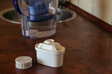 Tap water purification cartridge and silicon filter on the table.