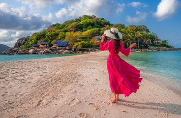  Asian woman walking on the beach of separated sea on the island of Koh nangyuan in Thailand.