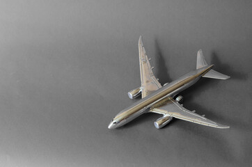 Silver airplane model on a gray background.