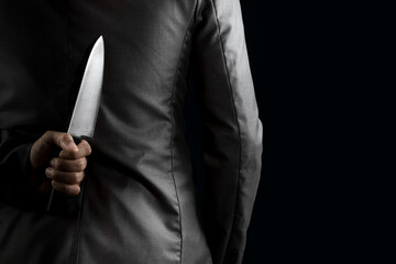businessman hide knife behind back - obrazy, fototapety, plakaty