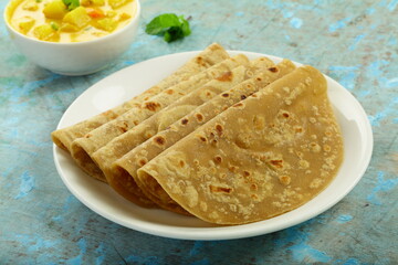 Top view- Indian recipes background- Chapati with vegetable korma.