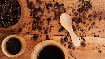 coffee beans and cup on the wooden background.