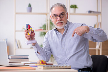 Old male teacher in the classroom