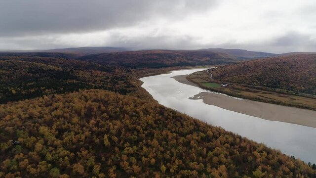 Aerial view of the Tenojoki river, on a dark rainy, autumn day, near Utsjoki, in Lapland, Finland - dolly, drone shot