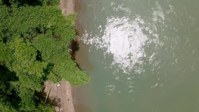 Backpackers walking on riverbank, Yuli town in Yangshuo China, aerial view