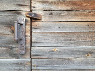 ancient wooden wall with a door, doorhandle and and a lock