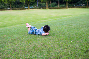 岐阜県の公園で寝ころんで遊ぶ日本人の赤ちゃん