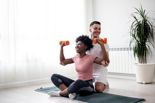 Multiethnic couple exercise at home early in the morning