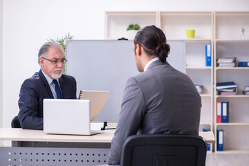Fototapeta premium Old and young businessmen in business meeting concept