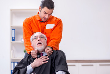 Old male judge meeting with young captive in courthouse
