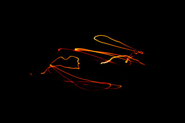 Creative Conceptual Fine Art Photography Motion Blur Sparkle Light Trail On Dark Background Copy Space For Text. Artistic design by lamp fire flame line at night slow shutter speed of camera exposure.