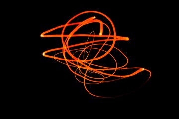 Creative Conceptual Fine Art Photography Motion Blur Sparkle Light Trail On Dark Background Copy Space For Text. Artistic design by lamp fire flame line at night slow shutter speed of camera exposure.