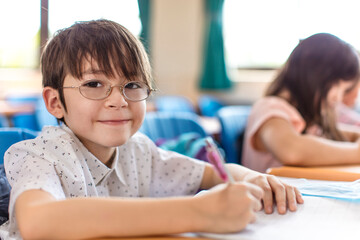 happy little boy studying in the classroom