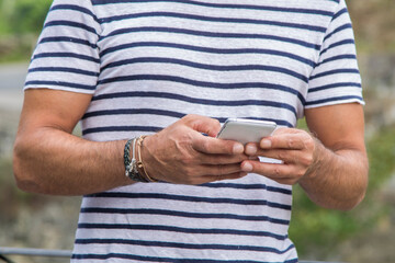 senior man walking and using mobile phone