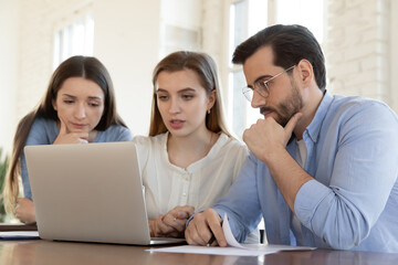 Colleagues working on project together, solving problem, discussing strategy, sharing ideas, employees team looking at laptop screen, brainstorming, manager consulting clients at meeting