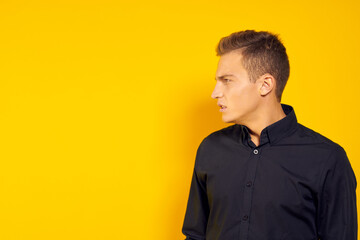 emotional man in black shirt lifestyle yellow isolated background