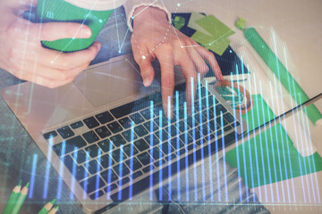 Double exposure of woman hands typing on computer and forex chart hologram drawing. Stock market invest concept.