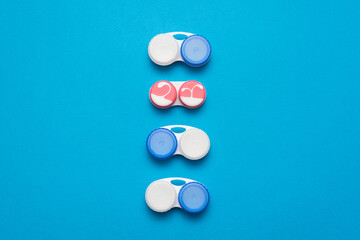 Contact lenses containers on the blue flat lay background.