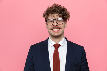 happy young businessman in suit wearing glasses and smiling