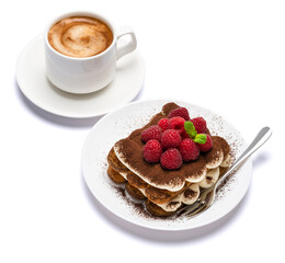 portion of Classic tiramisu dessert with raspberries and cup of fresh hot espresso isolated on white background - clipping path