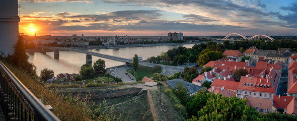 View of the city of Novi Sad and the Danube river, the city of Petrovaradin at sunset from the fortress. Panorama banner format