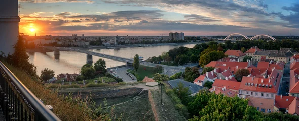 Foto op Canvas View of the city of Novi Sad and the Danube river, the city of Petrovaradin at sunset from the fortress. Panorama banner format © olezzo
