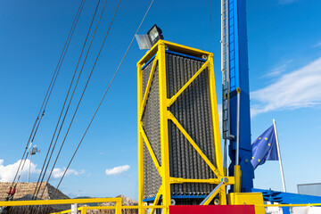 The catapult tensioning mechanism made of many springs and hydraulic cylinders against the blue sky.