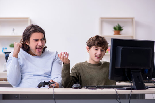 Father and son playing computer games