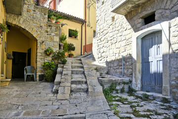 A narrow street among the old houses of Castelmezzano, a rural village in the Basilicata region, Italy.
